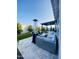 Inviting backyard patio with stylish seating, a modern fire pit, and lush landscaping under a blue sky at 12047 E Sereno Rd, Gold Canyon, AZ 85118