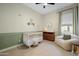 Cozy Bedroom with a crib, changing table, and comfortable seating area at 12047 E Sereno Rd, Gold Canyon, AZ 85118