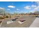 Community common area features desert landscaping and several cornhole setups at 12047 E Sereno Rd, Gold Canyon, AZ 85118