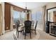Inviting dining room with a stylish chandelier, wood-accented wall, and view to the exterior at 12047 E Sereno Rd, Gold Canyon, AZ 85118