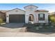 Charming single-story home featuring a well-manicured front yard, a tiled roof, and an arched gated front entry at 12047 E Sereno Rd, Gold Canyon, AZ 85118