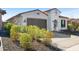 Well-maintained single-story home featuring desert landscaping, a paved driveway, and an arched gated front entry at 12047 E Sereno Rd, Gold Canyon, AZ 85118