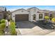 Charming single-story home with desert landscaping, a paved driveway, and an arched gated front entry at 12047 E Sereno Rd, Gold Canyon, AZ 85118