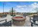 Community firepit features string lights, chairs, and desert landscaping at 12047 E Sereno Rd, Gold Canyon, AZ 85118