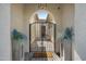 Inviting front entrance featuring a black iron gate leading to a beautifully decorated outdoor courtyard at 12047 E Sereno Rd, Gold Canyon, AZ 85118