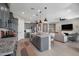 Modern kitchen with gray cabinets, an island with seating, and an open floor plan at 12047 E Sereno Rd, Gold Canyon, AZ 85118