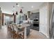 Elegant kitchen with gray cabinets, granite countertops, and a large central island at 12047 E Sereno Rd, Gold Canyon, AZ 85118