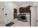 Functional laundry room with modern washer and dryer, storage cabinets, and ample lighting at 12047 E Sereno Rd, Gold Canyon, AZ 85118