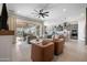 Bright and open living area with comfortable seating, a sliding glass door, and modern finishes at 12047 E Sereno Rd, Gold Canyon, AZ 85118