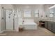 A luxurious main bathroom featuring a soaking tub, walk-in shower, and vanity at 12047 E Sereno Rd, Gold Canyon, AZ 85118