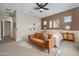 Spacious main bedroom has neutral tones, a comfortable seating area, and plenty of natural light at 12047 E Sereno Rd, Gold Canyon, AZ 85118