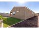 Exterior view of house and backyard with artificial turf and rock landscaping at 12324 W Northview Ave, Glendale, AZ 85307