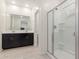 Modern bathroom featuring a glass enclosed shower and double sink vanity at 12324 W Northview Ave, Glendale, AZ 85307