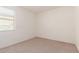Bright, carpeted bedroom with large window offering natural light at 12324 W Northview Ave, Glendale, AZ 85307