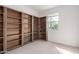 Bedroom with light carpet, a window, and wooden bookcase-style built-ins at 12324 W Northview Ave, Glendale, AZ 85307