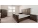 Well-furnished bedroom with a wooden bed, dresser, and carpet at 12324 W Northview Ave, Glendale, AZ 85307