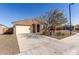 Single story home with desert landscaping, two car garage, and neutral colored stucco exterior at 12324 W Northview Ave, Glendale, AZ 85307