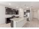 Modern kitchen with dark cabinets, granite countertops, stainless steel appliances, and tile backsplash at 12324 W Northview Ave, Glendale, AZ 85307