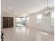 Open living space featuring light tile flooring, modern chandelier, and natural light from the rear windows and sliding door at 12324 W Northview Ave, Glendale, AZ 85307