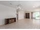 Spacious living room with light tile floors, recessed lights, updated fixture and sliding door access to the backyard at 12324 W Northview Ave, Glendale, AZ 85307
