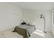 Bright bedroom featuring a plush rug, a cozy bed with an olive-green coverlet, and a modern floor lamp at 1455 N Alma School Rd # 38, Mesa, AZ 85201