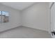 This bedroom features neutral walls, carpet, and a window letting in natural light at 1455 N Alma School Rd # 38, Mesa, AZ 85201