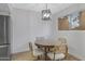 A dining nook features a round table, a stylish light fixture, and bright walls at 1455 N Alma School Rd # 38, Mesa, AZ 85201