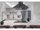 Modern kitchen featuring white cabinets, stainless steel appliances, and an island cooktop at 1455 N Alma School Rd # 38, Mesa, AZ 85201