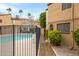 Community pool with a secure fence and lush landscaping around the property at 1455 N Alma School Rd # 38, Mesa, AZ 85201