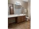 Bathroom with vanity, sink, mirror, toilet and linen closet provides a tidy and relaxing space at 14575 W Mountain View Blvd # 11313, Surprise, AZ 85374