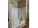 Bathroom area features a shower and tub with white tile and a white shower curtain at 14575 W Mountain View Blvd # 11313, Surprise, AZ 85374