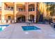 View of a resort-style community featuring a hot tub, seating, and well-kept landscaping at 14575 W Mountain View Blvd # 11313, Surprise, AZ 85374