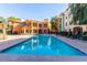 Resort-style community pool with ample lounge seating and well-manicured landscaping at 14575 W Mountain View Blvd # 11313, Surprise, AZ 85374