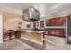 Gourmet kitchen with stainless steel appliances, center island, and rich wooden cabinetry at 14575 W Mountain View Blvd # 11313, Surprise, AZ 85374