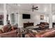 Well-appointed living room featuring leather seating, modern decor, and a wall-mounted television at 14575 W Mountain View Blvd # 11313, Surprise, AZ 85374