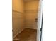 Walk-in closet includes wire shelving, tile flooring, and a neutral color scheme at 14575 W Mountain View Blvd # 11313, Surprise, AZ 85374