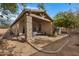 Charming backyard patio with stone columns and cozy seating area for outdoor relaxation at 1473 W Flamingo Dr, Chandler, AZ 85286