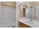 Bathroom with white tub, sink, medicine cabinet, and wood vanity with light tile flooring at 1473 W Flamingo Dr, Chandler, AZ 85286