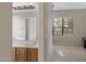 Bathroom featuring a vanity and mirror, with a glimpse into an adjacent bedroom at 1473 W Flamingo Dr, Chandler, AZ 85286