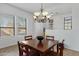 Inviting dining room with a chandelier and large windows, perfect for Gathering gatherings and entertaining guests at 1473 W Flamingo Dr, Chandler, AZ 85286