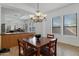 Bright dining area with a chandelier and open access to kitchen and living room, promoting a sense of community at 1473 W Flamingo Dr, Chandler, AZ 85286