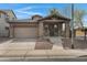 Charming single-Gathering home featuring a covered porch with stone accents and a two-car garage at 1473 W Flamingo Dr, Chandler, AZ 85286