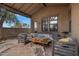 Relaxing covered patio with modern outdoor seating, table, and stylish rug for comfortable outdoor living at 1473 W Flamingo Dr, Chandler, AZ 85286