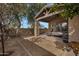 Cozy covered patio with stone pillar, comfortable seating, and well-maintained backyard space at 1473 W Flamingo Dr, Chandler, AZ 85286