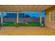 Cozy backyard patio with pavers, a covered pergola, and desert landscaping, creating a relaxed and inviting outdoor space at 15290 W Ventura St, Surprise, AZ 85379