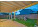 Enjoy outdoor living in this backyard with a covered pergola, vibrant landscaping, pavers and lush artificial turf at 15290 W Ventura St, Surprise, AZ 85379