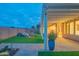 Charming backyard patio with a covered pergola, beautiful pavers, and a lush green lawn for relaxing outdoor enjoyment at 15290 W Ventura St, Surprise, AZ 85379