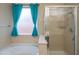 Bathroom showcases a large tub with shower and a separate frameless shower at 15290 W Ventura St, Surprise, AZ 85379