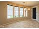 Dining area with backyard views through large windows and modern chandelier at 15290 W Ventura St, Surprise, AZ 85379