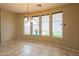 Dining area with backyard views through large windows and modern chandelier at 15290 W Ventura St, Surprise, AZ 85379